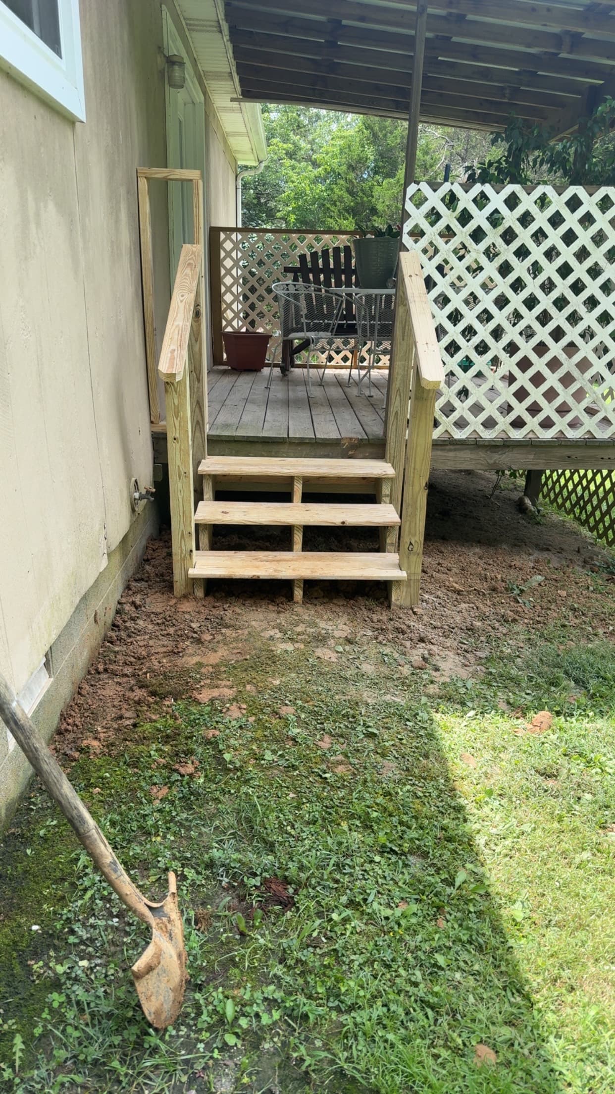 Timber steps with handrails leading to a covered deck