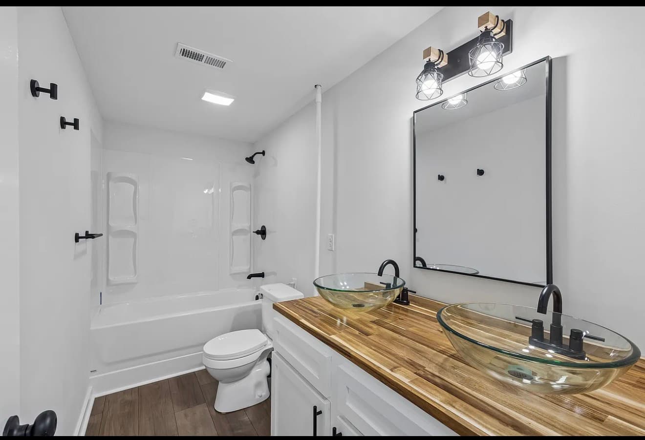 Bathroom mirror, plumbing fixtures, and hardware installed above a vanity