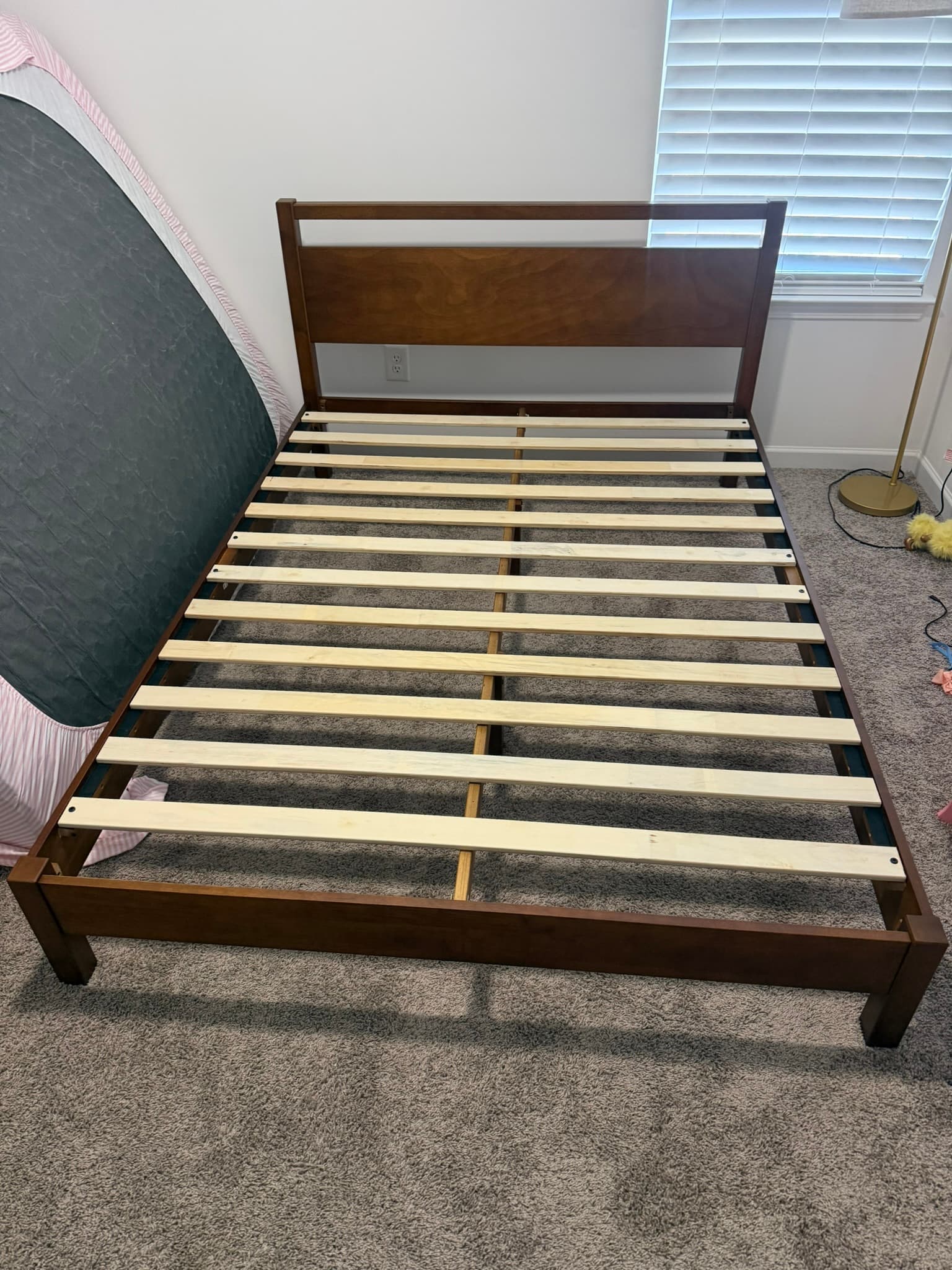 Assembled wooden bed frame in a bedroom