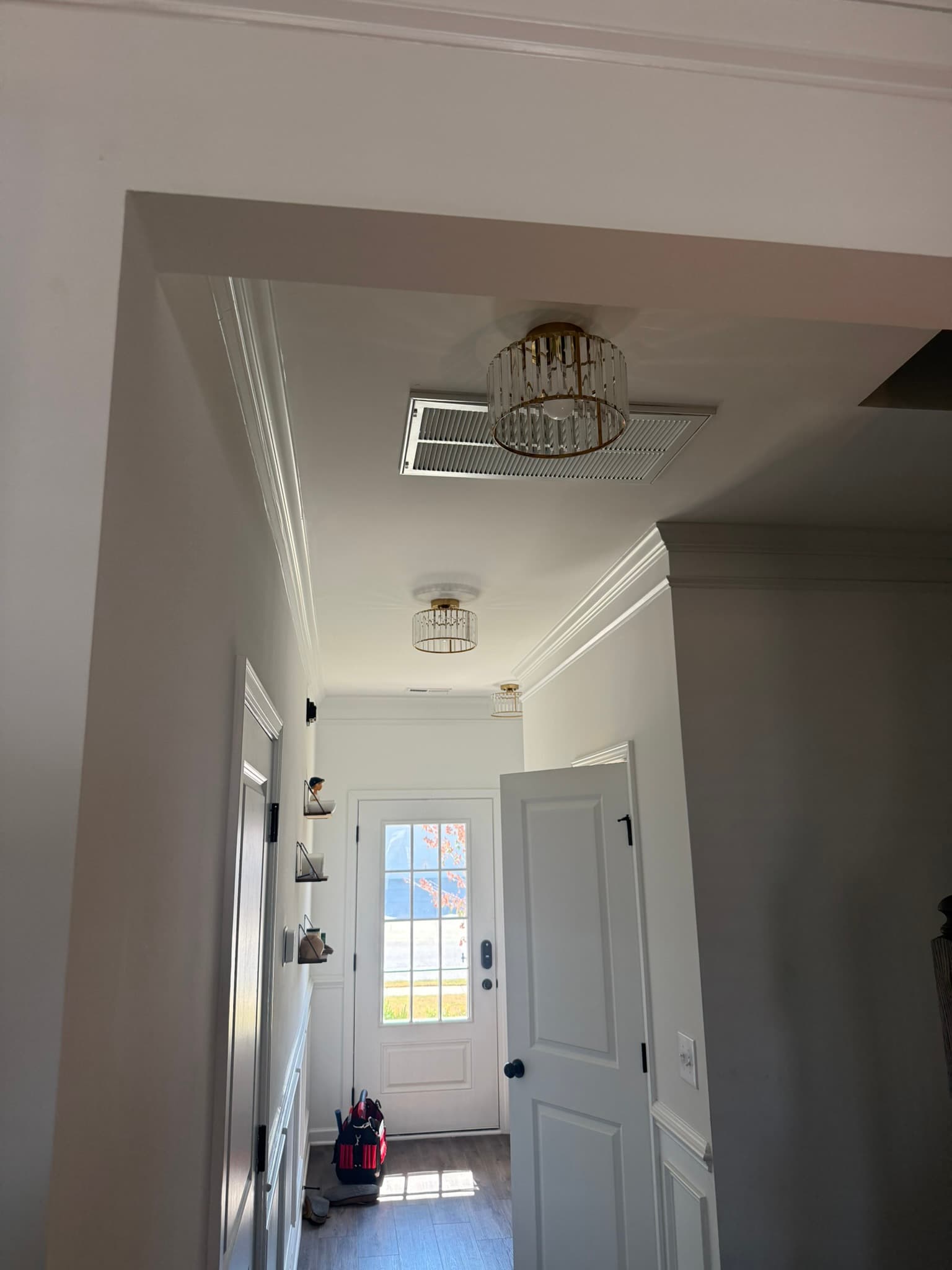 Pendant light fixtures installed along an entry hall