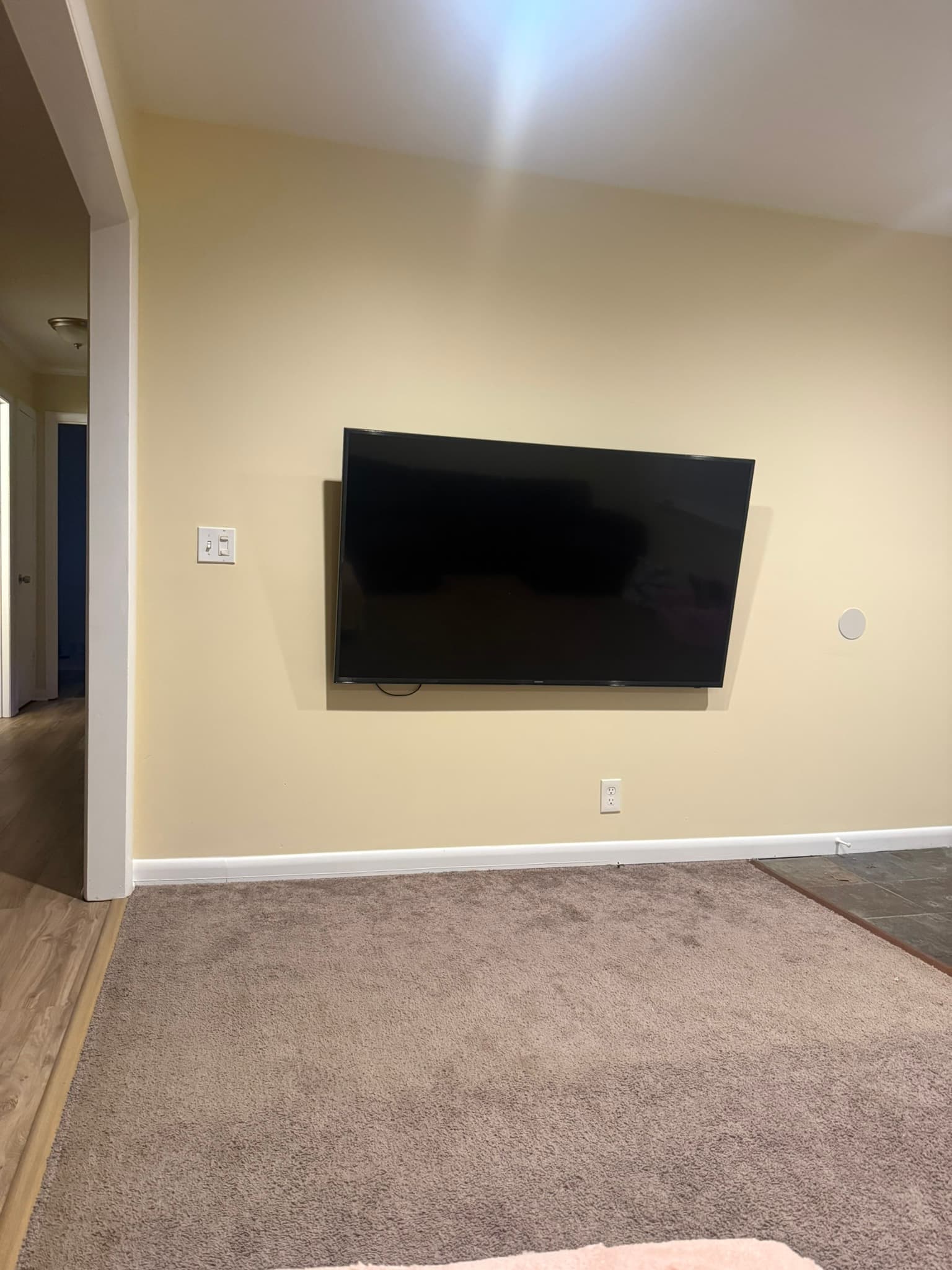 Flat-screen television mounted on an interior wall